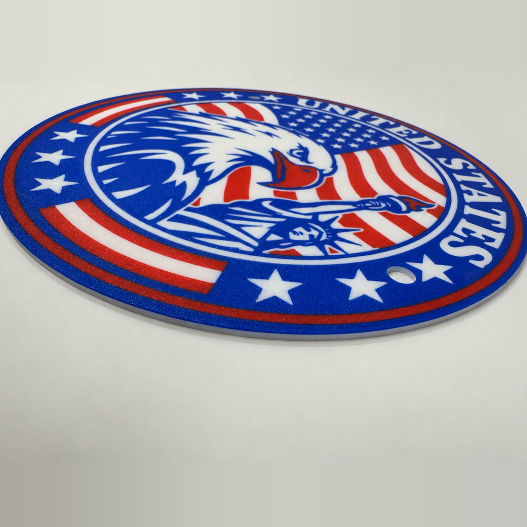 Angled photograph showing the printed texture and thin edge of the 9.5-inch United States seal with hanging holes